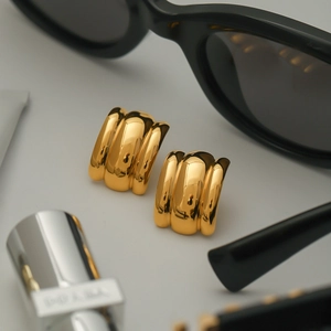 Chic gold triple-layered curved earrings with a sleek metallic finish and vintage style