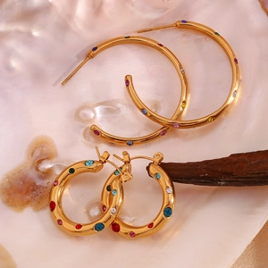 Detail of 18K gold plated square lava earrings with multicolored cubic zirconia in shells
