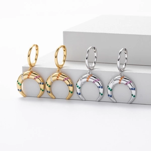 Close-up of crescent moon earrings with colorful crystals in gold and silver finish