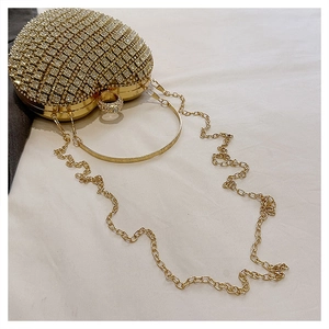 Detail of heart shaped rhinestone evening bag with gold metal frame and sparkling stones