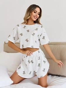 Detail of soft white pajamas set with bear prints and elastic waistband on a model