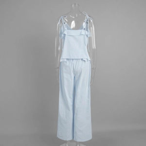 Close-up of light blue cotton camisole with ruffled hem and matching wide leg pants