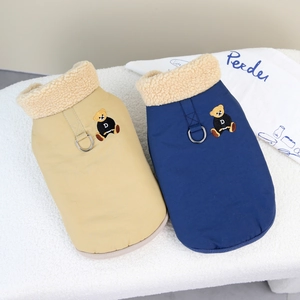 Close-up of winter pet vests with warm fleece collars and metal D-rings for leash attachment