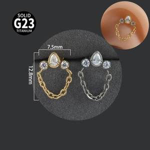 Detail of G23 titanium teardrop zircon chain earrings in silver and gold finishes