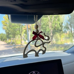 Minimalist wooden elephant car hanging decor with red bow detail on car rearview mirror