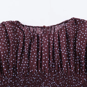 Polka dot wine red blouse featuring balloon sleeves and detailed elasticated waist design