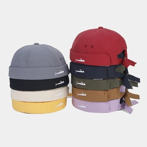 Close-up of cotton miki hat featuring minimalist whale embroidery and adjustable strap