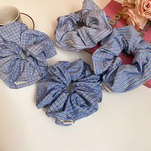 Set of four blue plaid and striped fabric scrunchies with elegant minimalist design