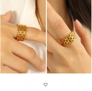 Detailed close-up of wide golden chain style ring with exaggerated geometric design