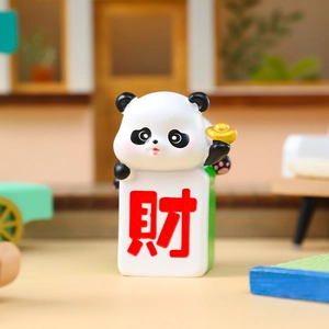 Panda figurine holding a green mahjong tile with Fortune character and gold ingot ornament