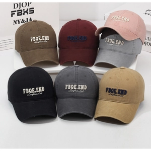Detail of washed cotton baseball caps in seven colors featuring letter embroidery