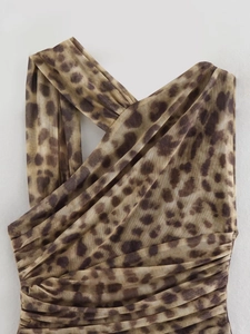 Detail of leopard print mesh top with pleated cross neckline and sheer fabric texture