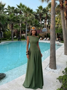 Elegant olive green one-shoulder evening gown with pleated waist detail at poolside