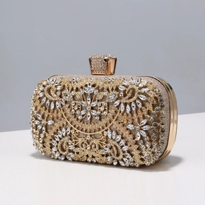 Detailed view of luxury gold evening clutch with floral rhinestone patterns and metal clasp