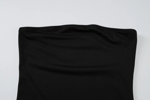 Detail of fine knit texture and reinforced hem on the black tube dress neckline