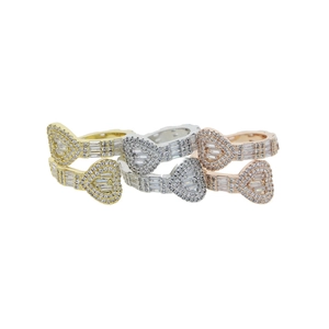 Detailed view of heart-shaped zircon rings in gold, silver, and rose gold finishes
