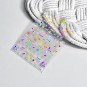 Macro detail of holographic summer beach nail stickers featuring palm trees and surfboards