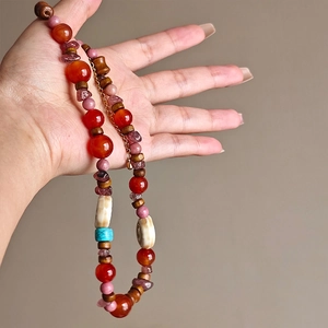 Handcrafted ethnic beaded necklace with agate turquoise and wooden beads in boho style