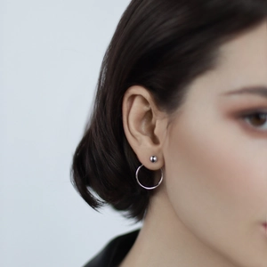 Detail of 925 sterling silver earring set showing minimalist ring and stud design