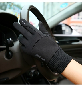 Close-up of black touch screen sport gloves on steering wheel showing material detail