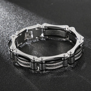 Macro shot of industrial steel cable links and rivet details on this men's titanium bracelet