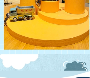 Detail of mini construction truck keychain with green cabin and yellow tipper body