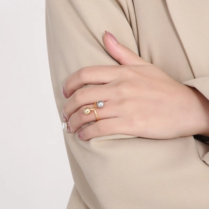 Minimalist stainless steel open ring featuring two polished beads in silver and gold tones