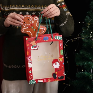 Christmas red paper gift bag with window, gingerbread man charm and festive handle