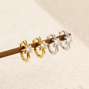 Macro shot of S925 sterling silver starburst ear cuffs in gold and silver finishes