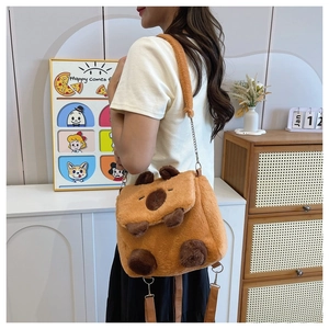 Brown Capybara plush crossbody bag shown on a model in a cozy indoor setting