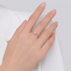 Elegant S925 sterling silver ring with pear-shaped pink opal on a model's finger