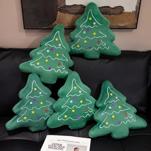 Set of five soft plush Christmas tree pillows in green with colorful dotted decorations