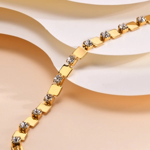 Detailed macro view of 18K gold plated square links and cubic zirconia stones on the bracelet