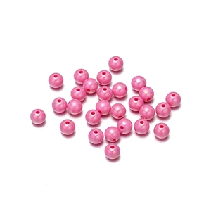 Detail of pink pearlescent acrylic round beads with holes for DIY jewelry making