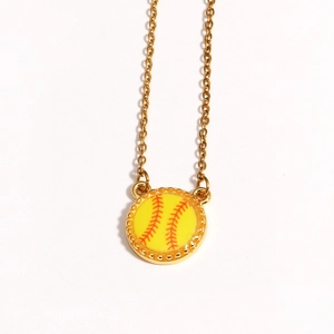 Detailed close-up of a golden baseball pendant necklace with red stitching on white back