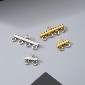 Macro view of gold and silver multi-hole stainless steel connectors for jewelry making