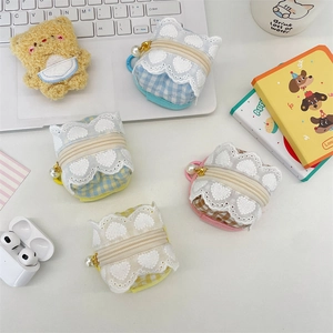 Cute plaid fabric earphone case with lace trim and bear plush pouch on white desk