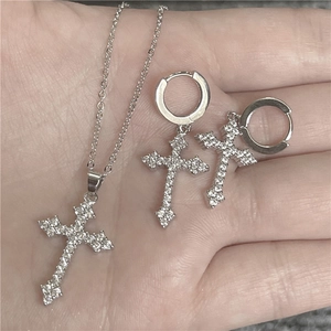 Sparkling silver cross necklace and hoop earrings set with rhinestones on model