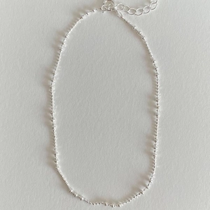 Detail of S925 sterling silver beaded anklet with lobster clasp and extension chain