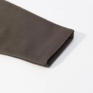Detailed macro view of gray wool knit sleeve cuff showcasing textured fabric and stitching