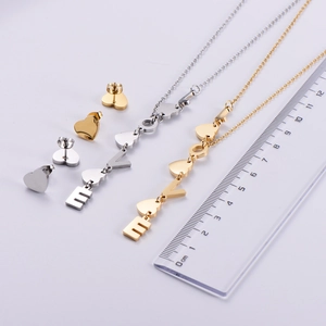 Macro detail of the gold and silver LOVE letter pendant necklace set with measurements