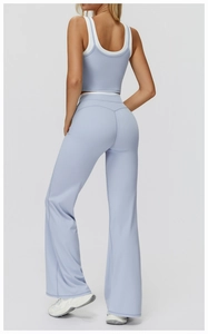 Detail of high-waist flared yoga pants and dual-strap sports bra in light lavender blue