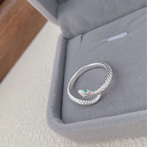 S925 sterling silver snake ring with green stone eye on grey velvet jewelry box