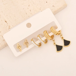 Three-piece gold earring set with music note, rhinestone hoop, and black fan pendants