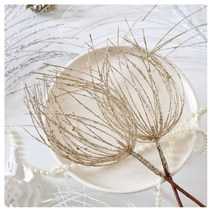 Detailed view of golden glitter branches for Christmas tree decor in a premium gift setting