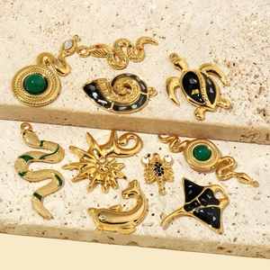Gold stainless steel ocean and animal charms set on a textured stone background
