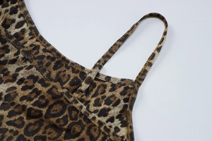Detail of adjustable thin shoulder straps and silver buckles on leopard print mesh bodysuit