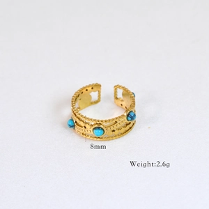 Detail of 14k gold plated ring featuring multiple blue round gemstones and 8mm width
