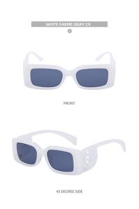 Detail view of white square sunglasses with gray lenses and golden interlocking logo