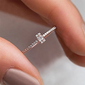 Macro view of rose gold ring featuring rectangular baguette zircon and pavé setting